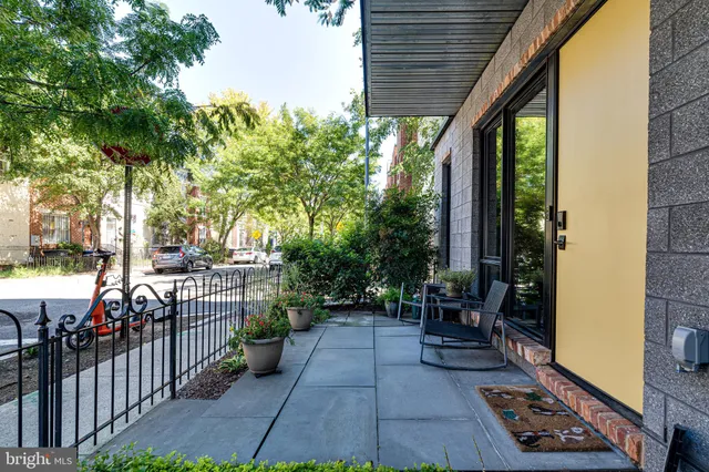 a dining room with couches a large mirror and a table