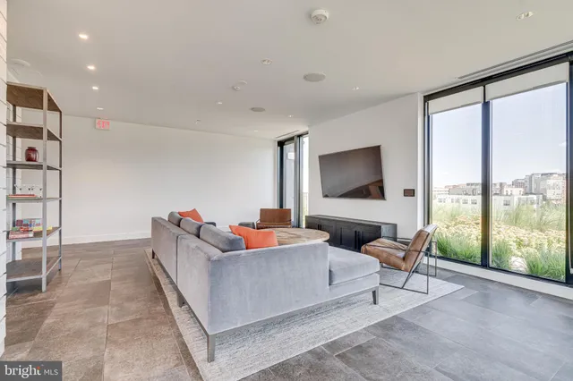 a front view of a house with plants and trees