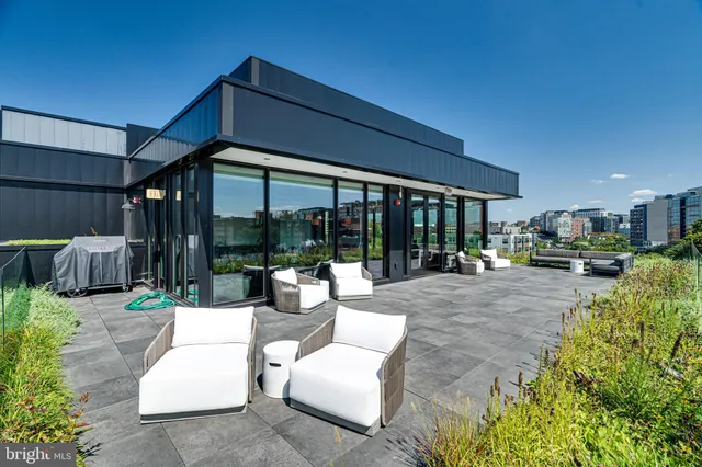 a view of a patio with a table chairs and a backyard