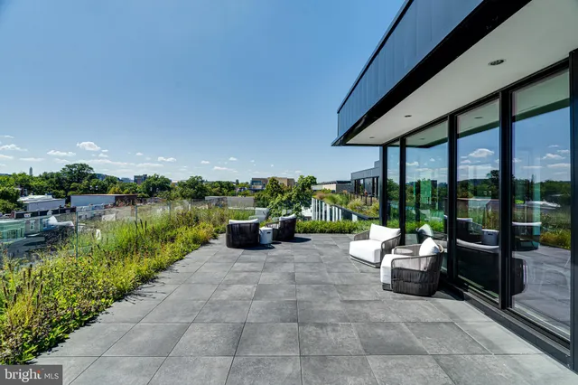 a view of swimming pool with outdoor seating and a garden
