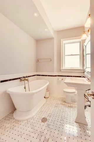 a bathroom with a bathtub and a sink