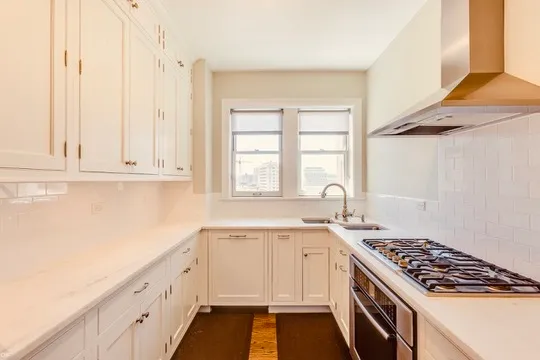 a kitchen with a sink stove and cabinets