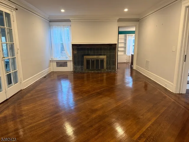 a living room with granite countertop wooden floor and chandelier