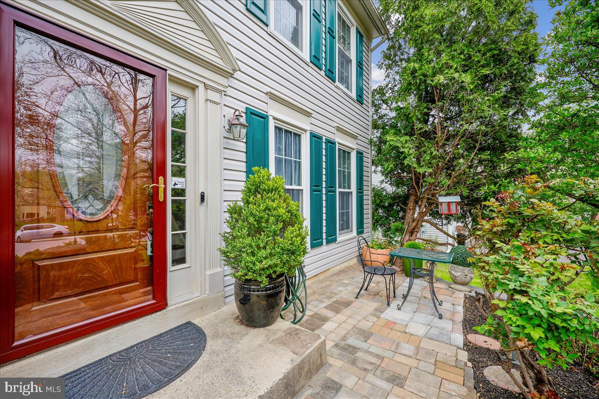 6132 Cornwall Terrace Frederick, MD 21701 - Photo 3 of 48 a view of patio with a table and chairs and potted plants