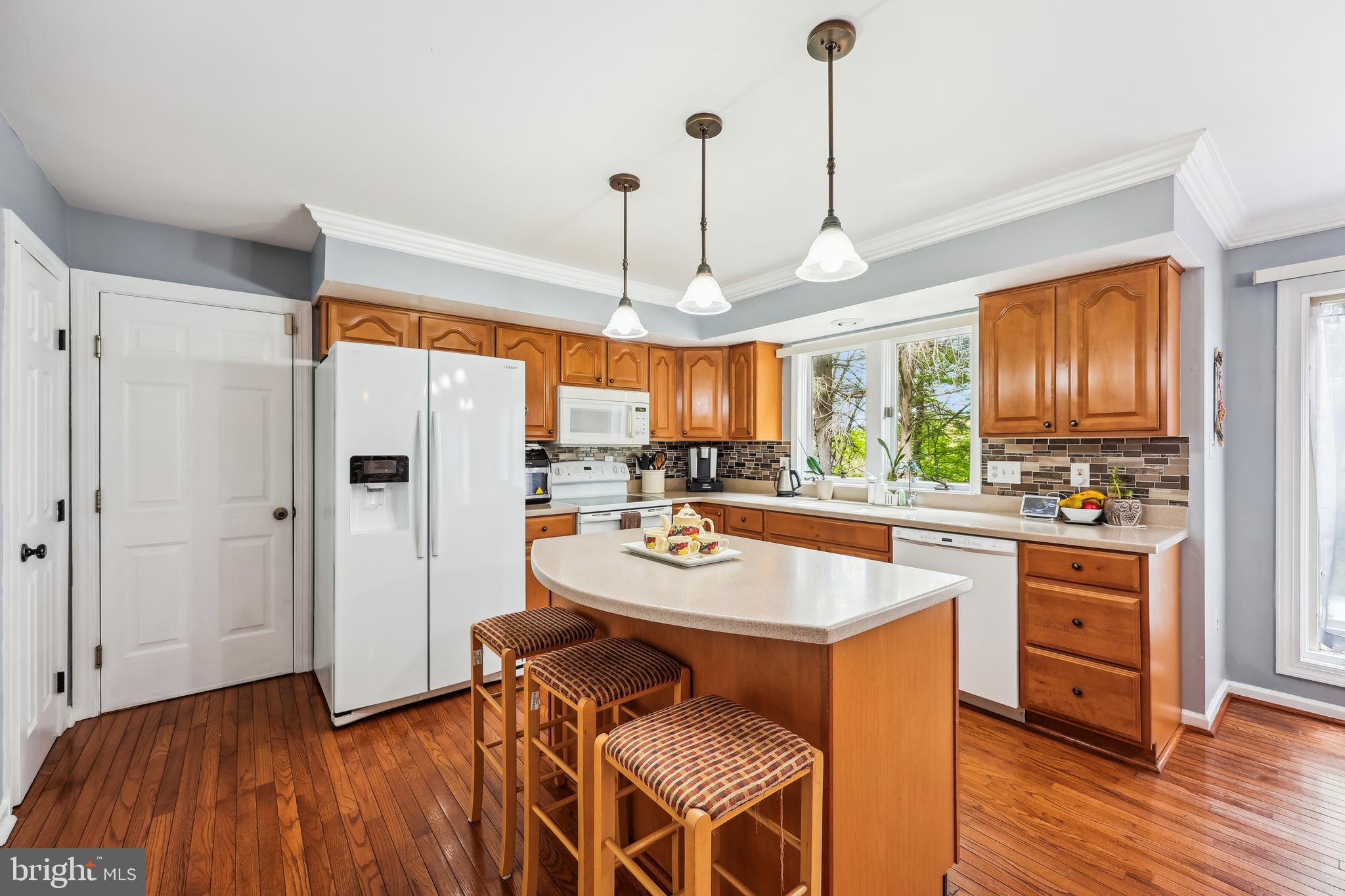 6132 Cornwall Terrace Frederick, MD 21701 - Photo 10 of 48 a kitchen with stainless steel appliances a dining table chairs stove and refrigerator