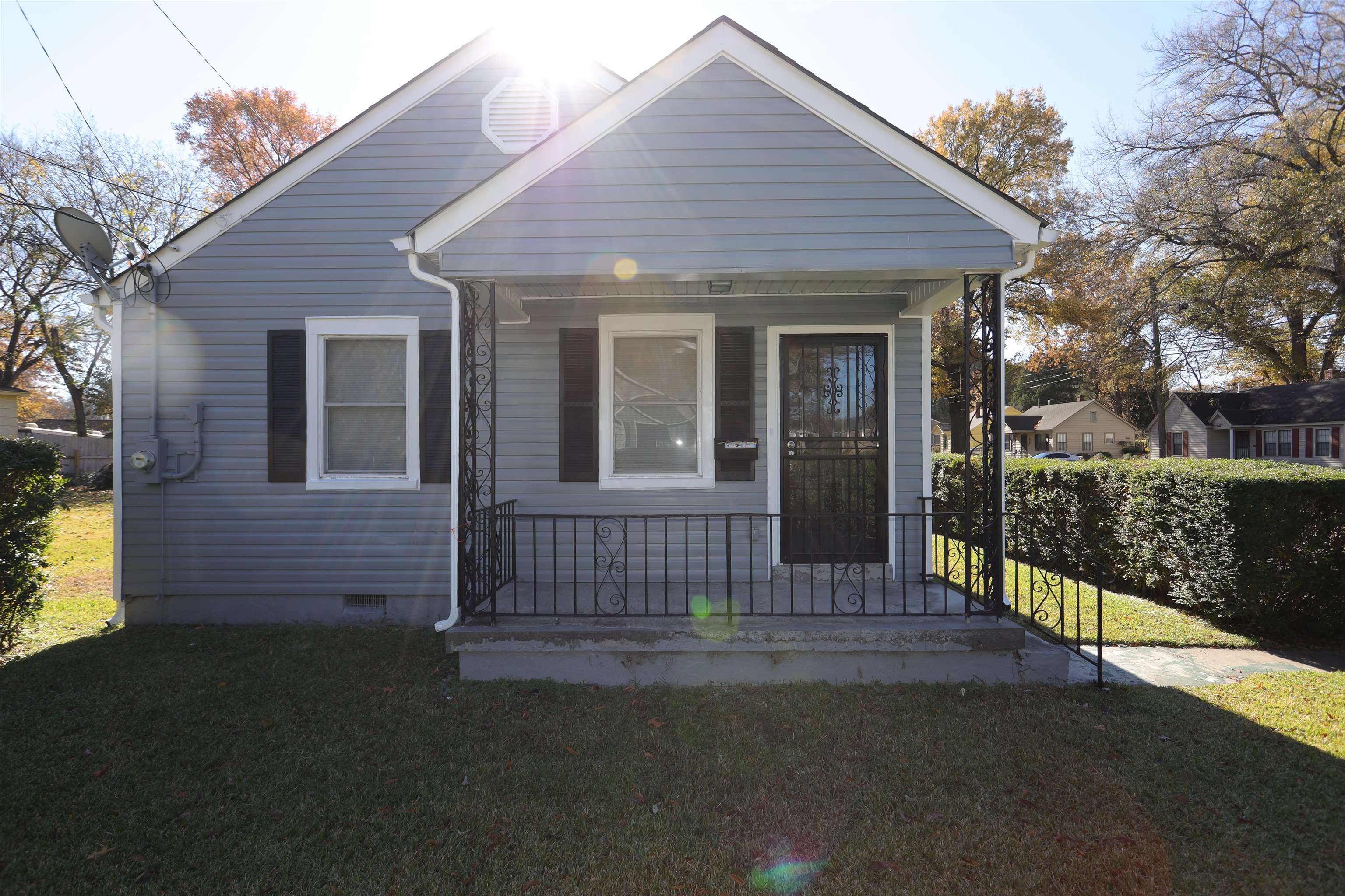 a front view of a house with a garden