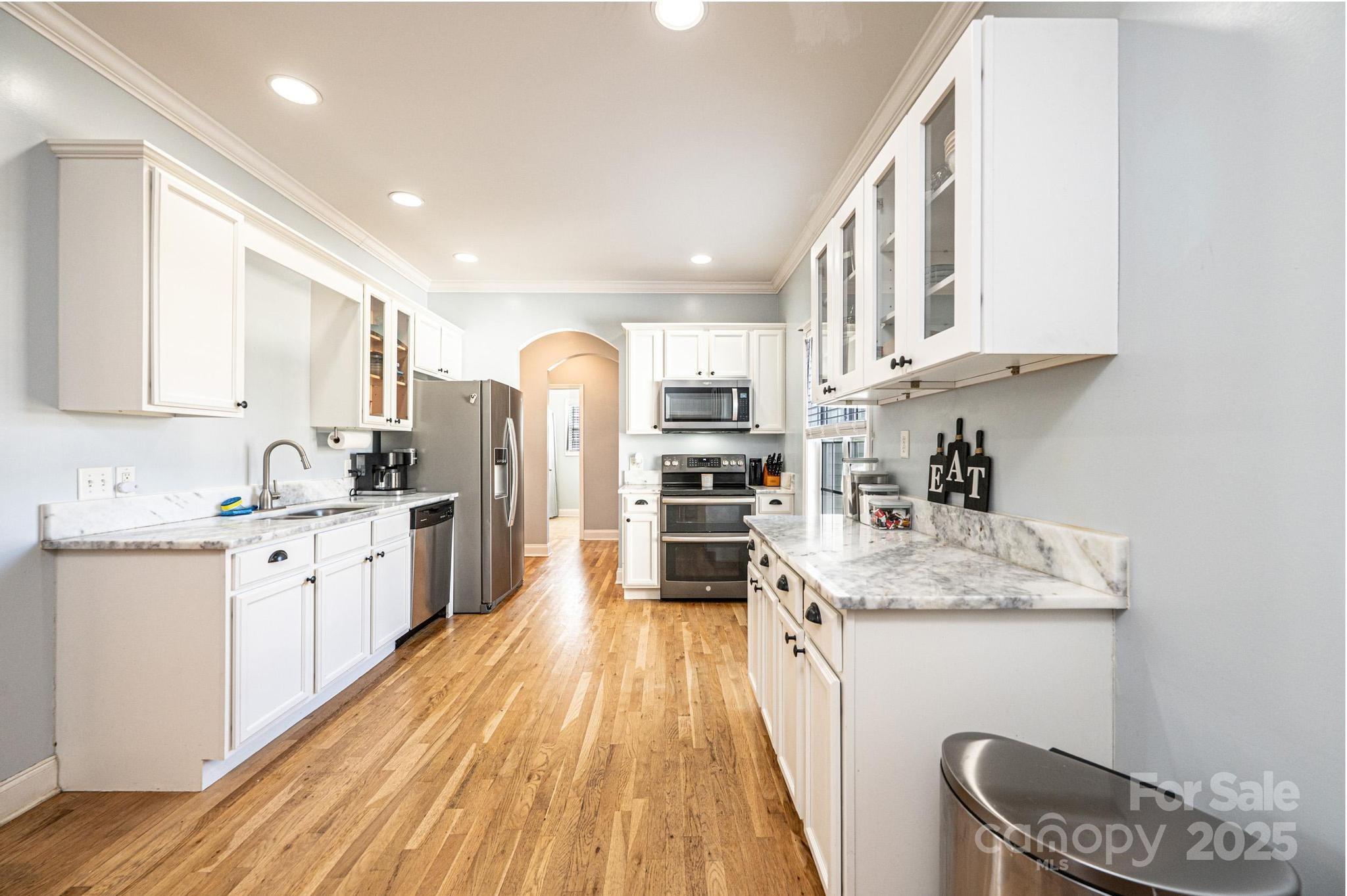1781 Herbie Circle Newton, NC 28658 - Photo 11 of 38 a kitchen with granite countertop a sink stove refrigerator and cabinets