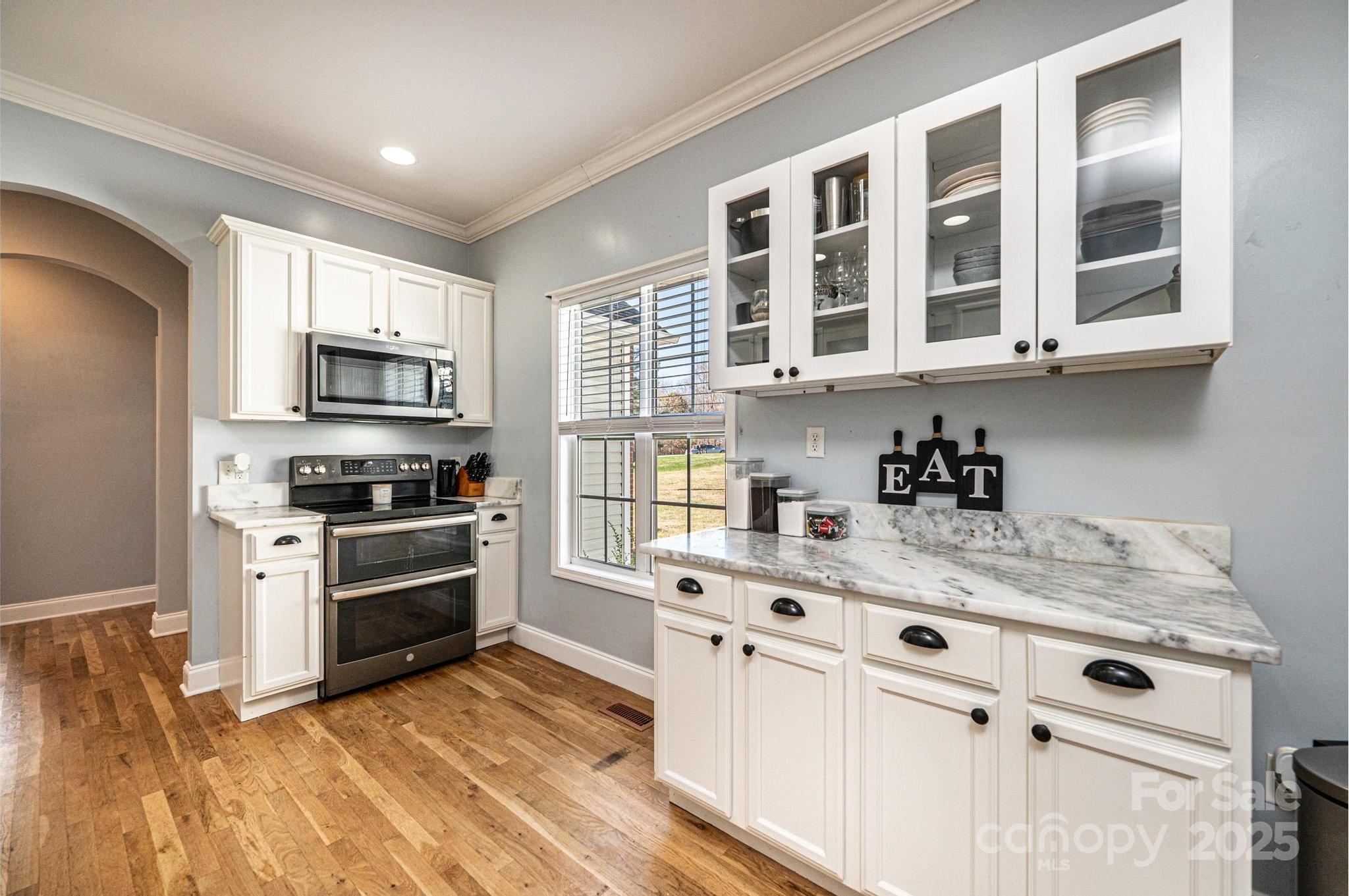 1781 Herbie Circle Newton, NC 28658 - Photo 13 of 38 a kitchen with granite countertop a stove and a sink