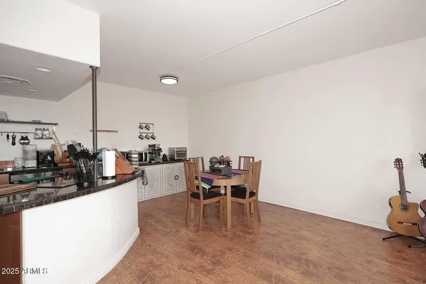 a dining room with furniture and wooden floor