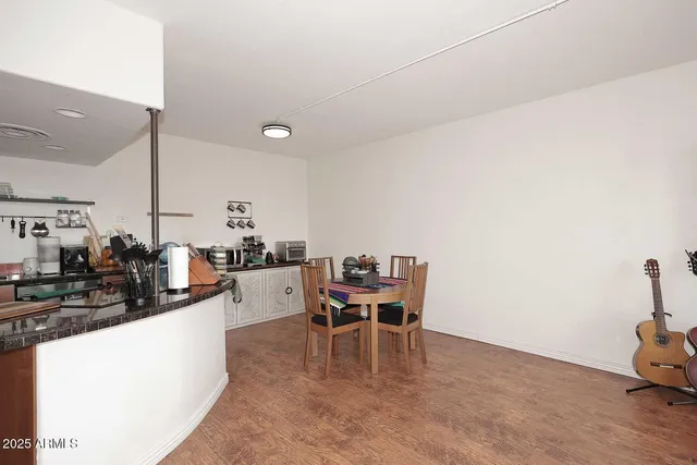 a dining room with furniture and wooden floor