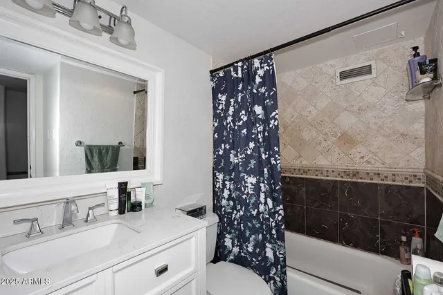 a view of a balcony with chairs and a potted plant