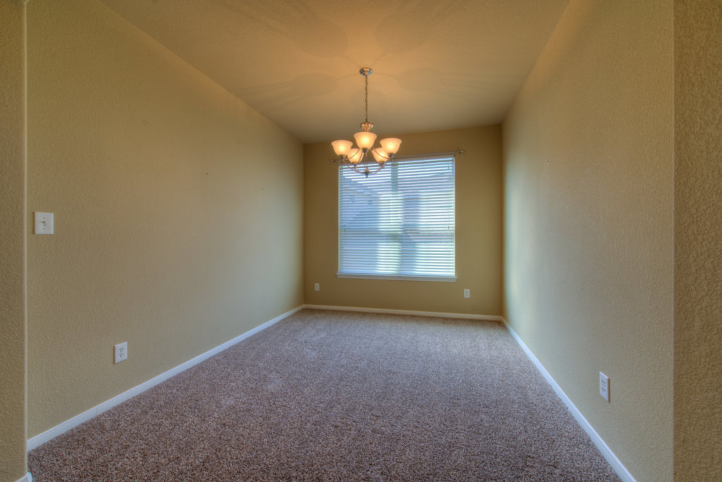 403 Limestone Trail Austin, TX 78737 - Photo 5 of 18 A classic chandelier illuminates this versatile, carpeted space with a single window.