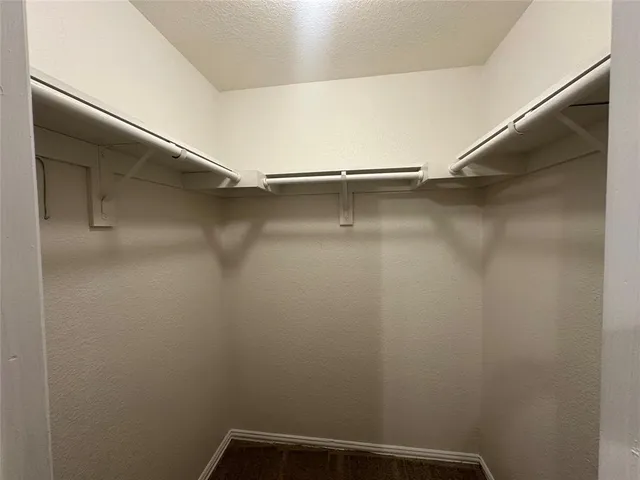 a hallway view with wooden floor and staircase