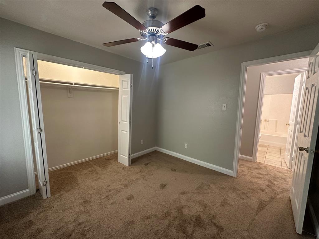 4147 Gladewater Road Dallas, TX 75216 - Photo 19 of 31 an empty room with closet and a chandelier fan