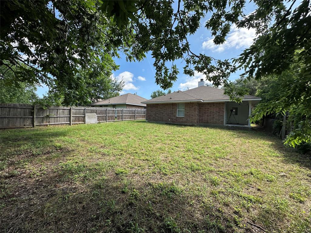4147 Gladewater Road Dallas, TX 75216 - Photo 25 of 31 a view of a house with a yard