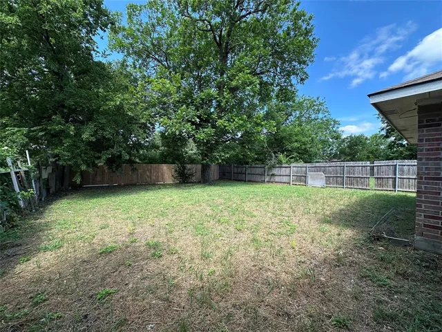 a backyard of a house with lots of green space