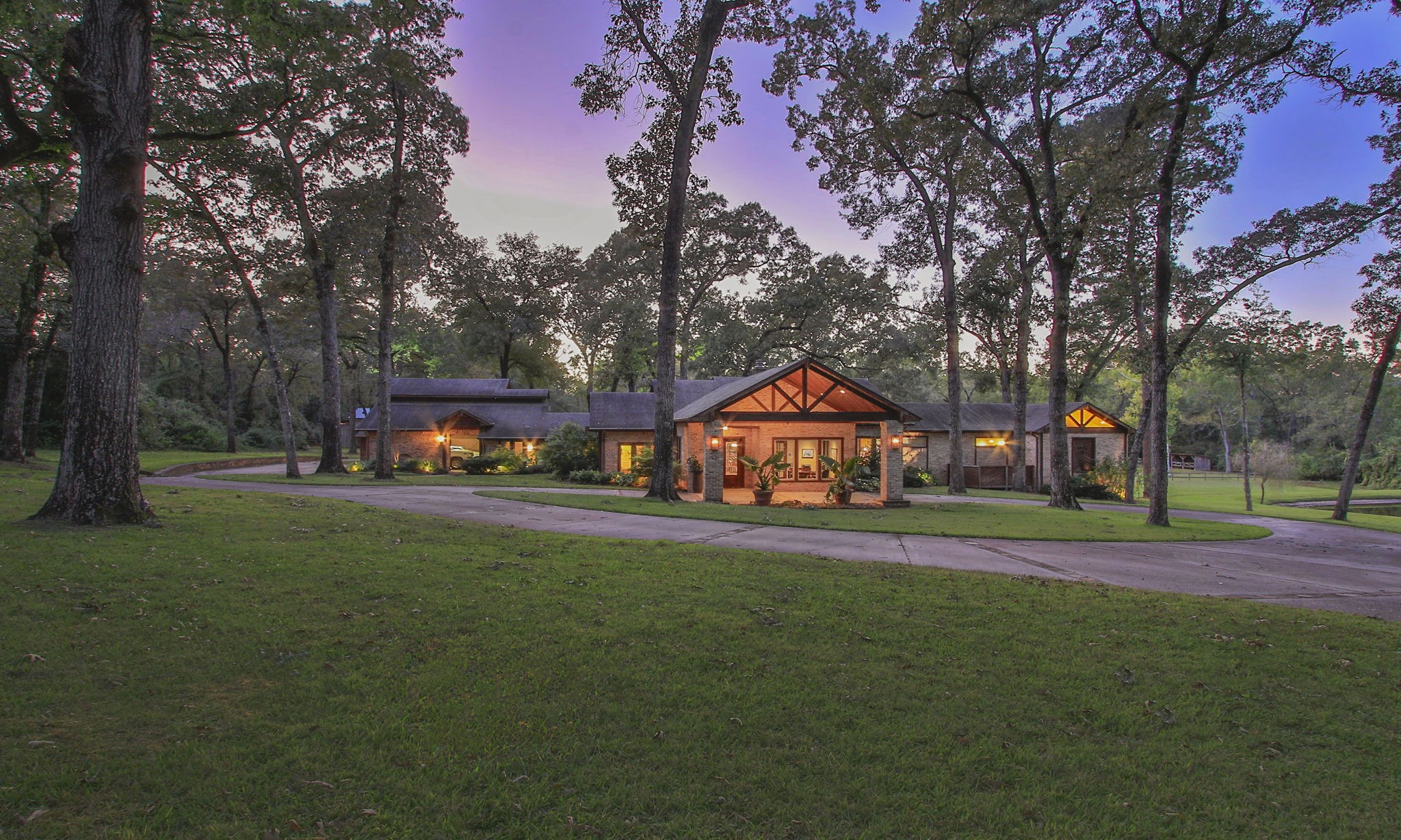 a front view of a house with a yard and trees