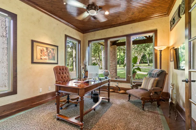 a living room with furniture large window and flat screen tv