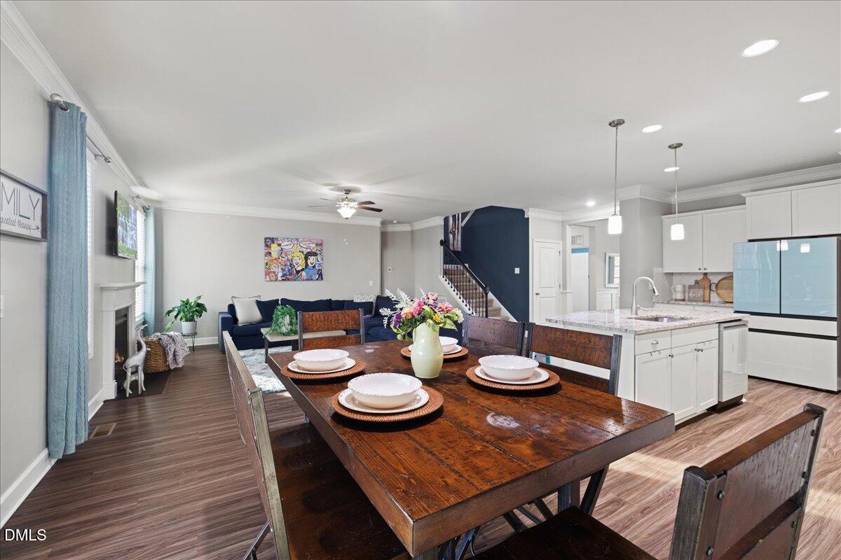 7804 Charters End Street Willow Spring, NC 27592 - Photo 9 of 43 a open dining room with furniture and wooden floor