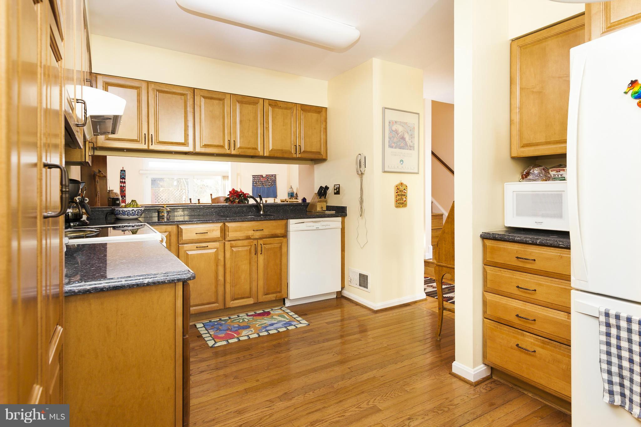 2005 Lyttonsville Road Silver Spring, MD 20910 - Photo 11 of 16 a kitchen with stainless steel appliances granite countertop a refrigerator and dishwasher a stove with wooden floor