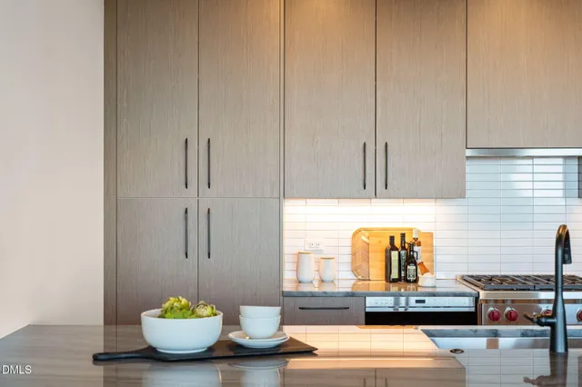 a living room with furniture and a dining table with kitchen view