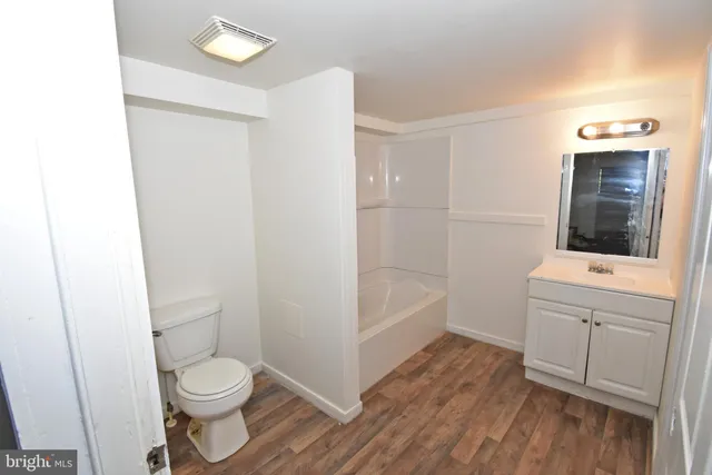 a view of a room that has a bed and a window in it