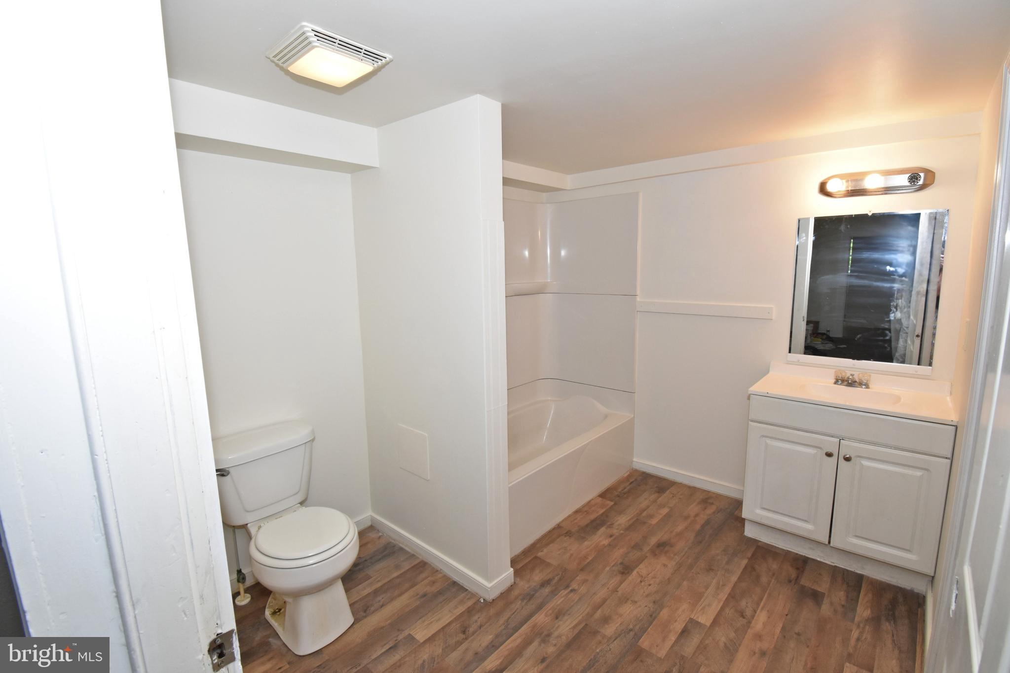 30472 Broad Street Princess Anne, MD 21853 - Photo 12 of 74 a bathroom with a toilet a sink and bathtub