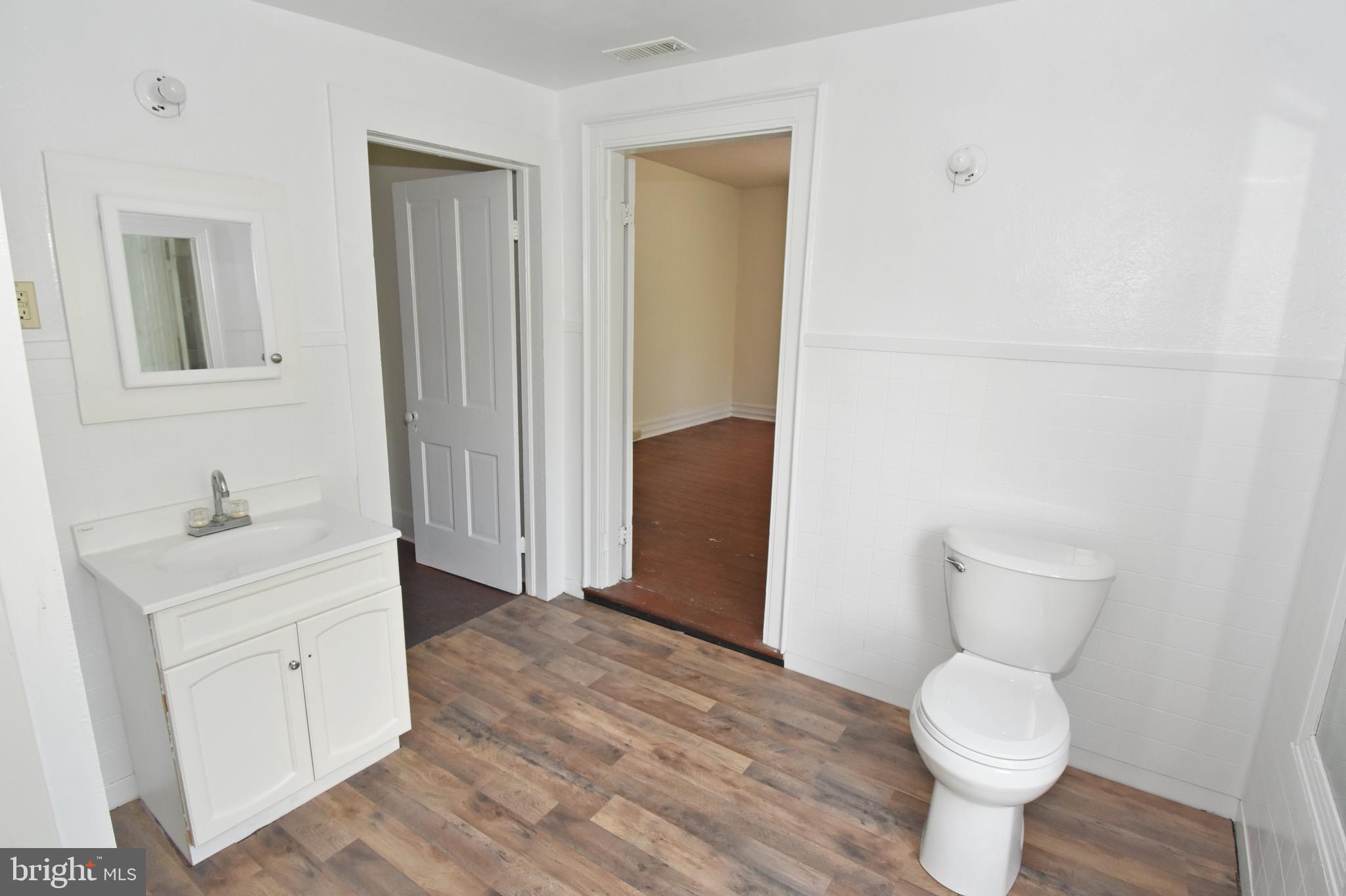 30472 Broad Street Princess Anne, MD 21853 - Photo 20 of 74 a bathroom with a toilet sink and a mirror