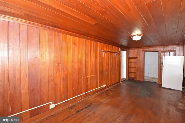 a view of staircase with wooden floor and white walls