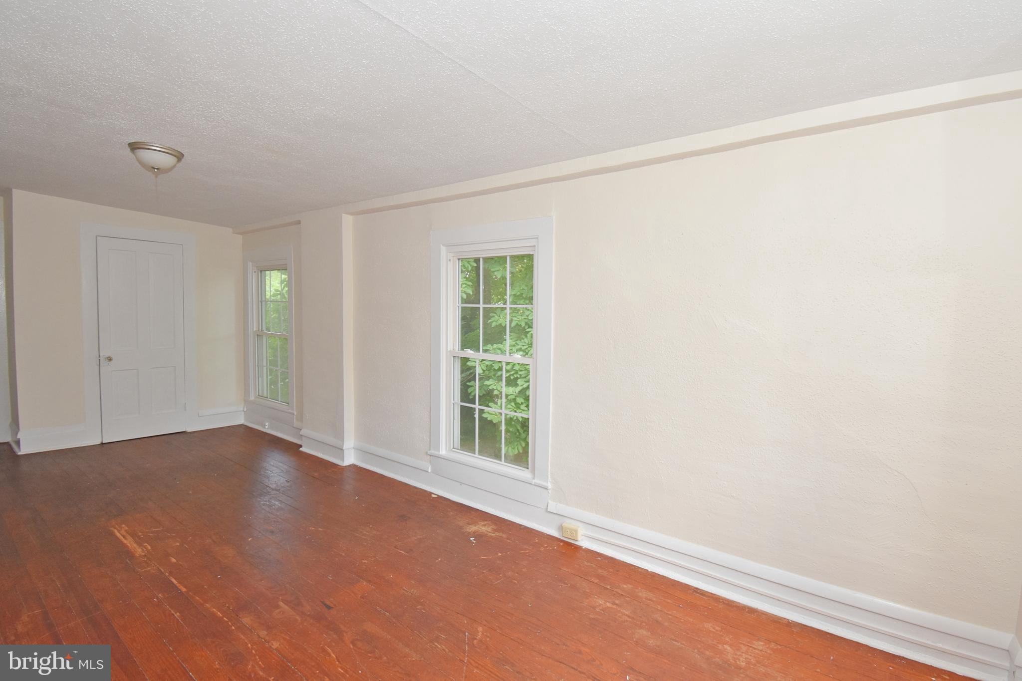 30472 Broad Street Princess Anne, MD 21853 - Photo 50 of 74 an empty room with wooden floor and windows