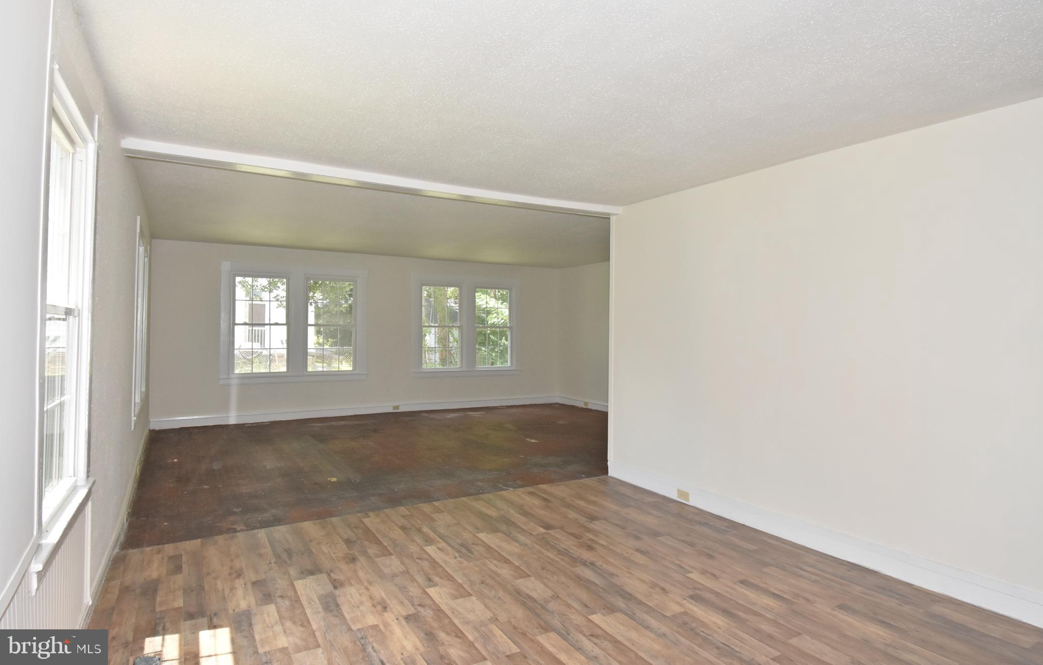 30472 Broad Street Princess Anne, MD 21853 - Photo 52 of 74 an empty room with wooden floor and windows