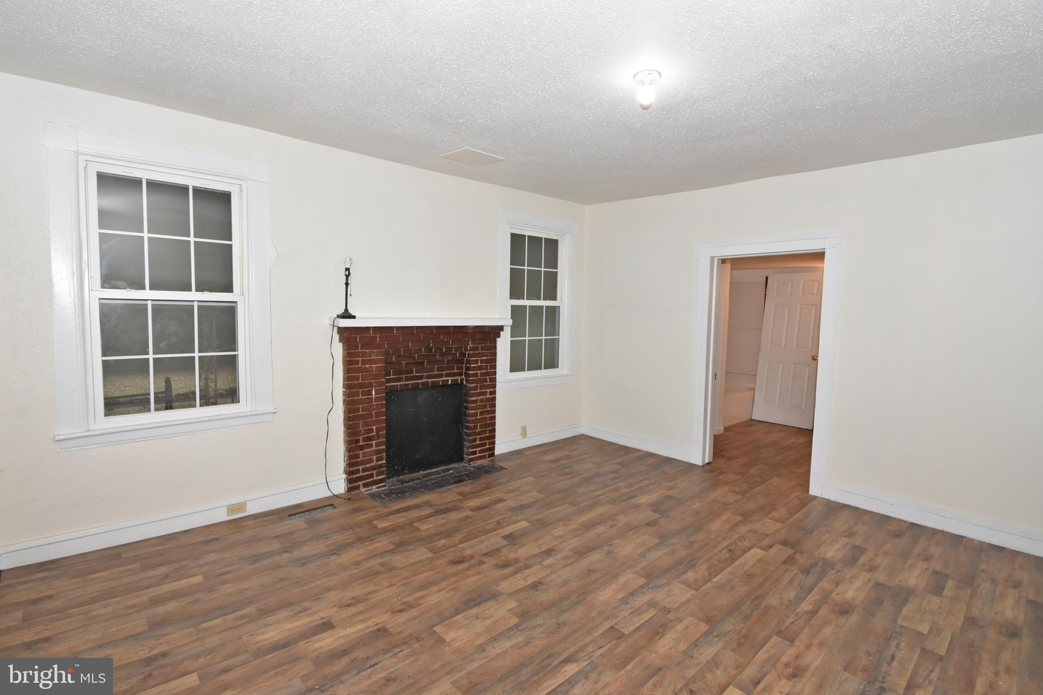 30472 Broad Street Princess Anne, MD 21853 - Photo 6 of 74 an empty room with windows and fireplace