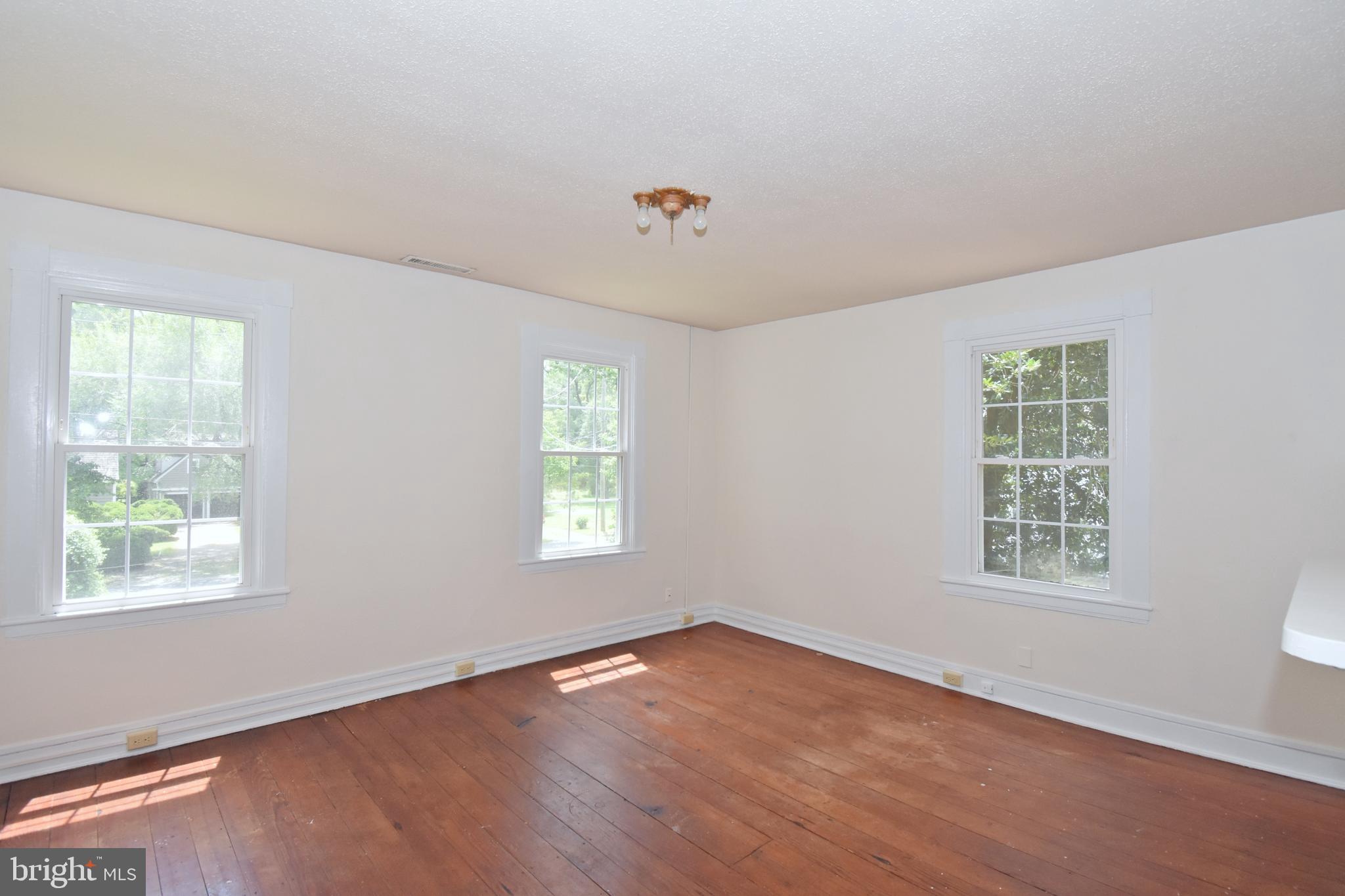 30472 Broad Street Princess Anne, MD 21853 - Photo 63 of 74 a view of an empty room with wooden floor and a window