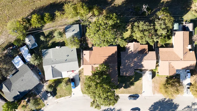 an aerial view of a house with a yard and garden