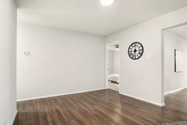 a view of a room with wooden floor