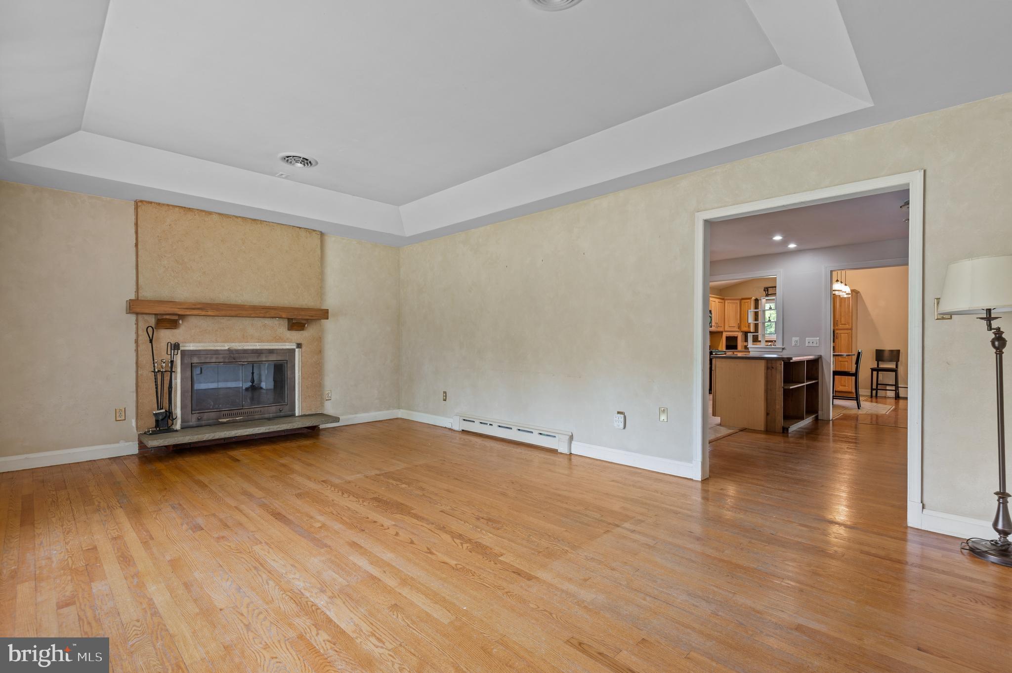 312 Whitaker Mill Road Fallston, MD 21047 - Photo 21 of 57 an empty room with wooden floor and fireplace