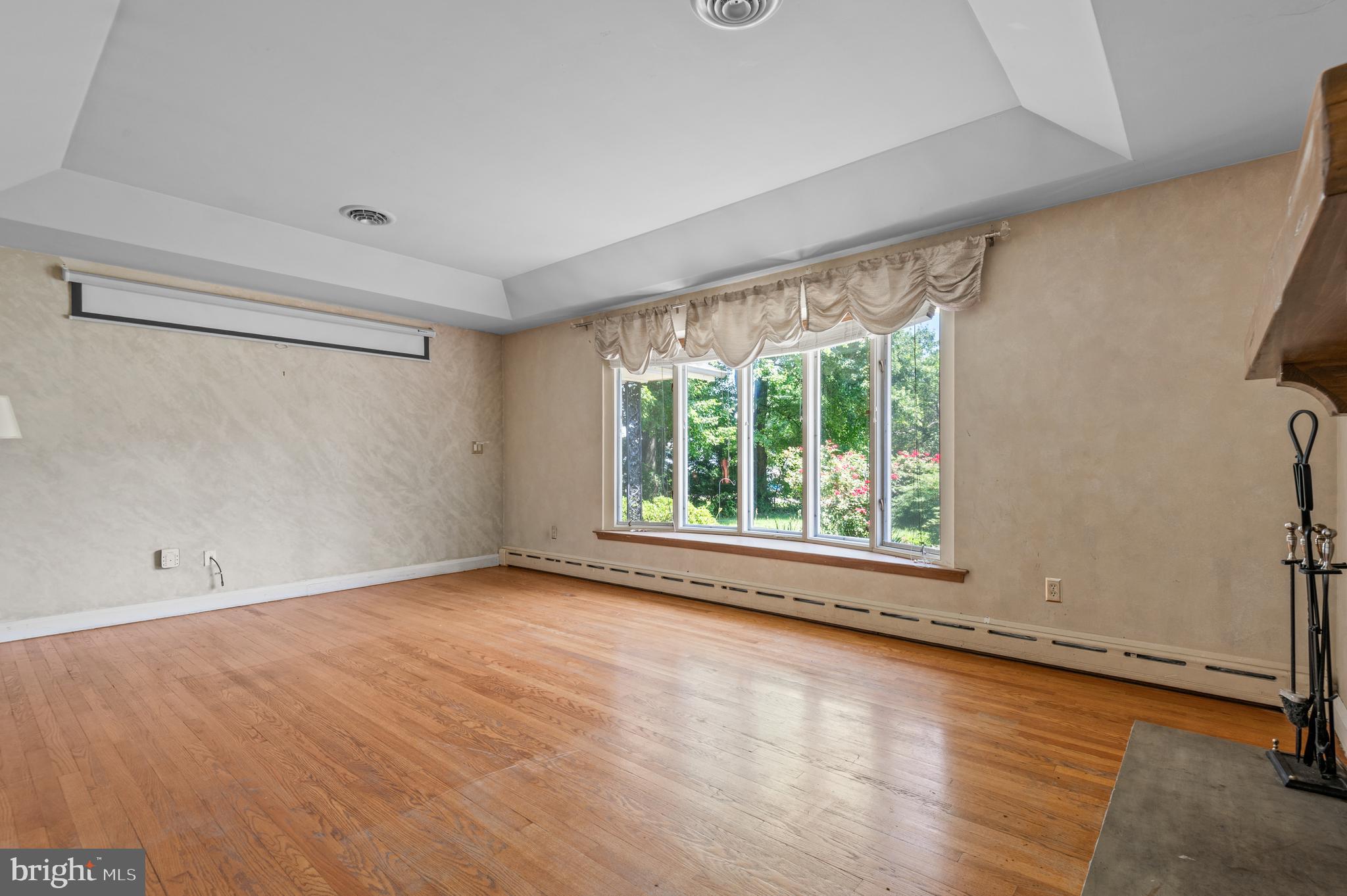 312 Whitaker Mill Road Fallston, MD 21047 - Photo 22 of 57 a view of an empty room with a window and wooden floor