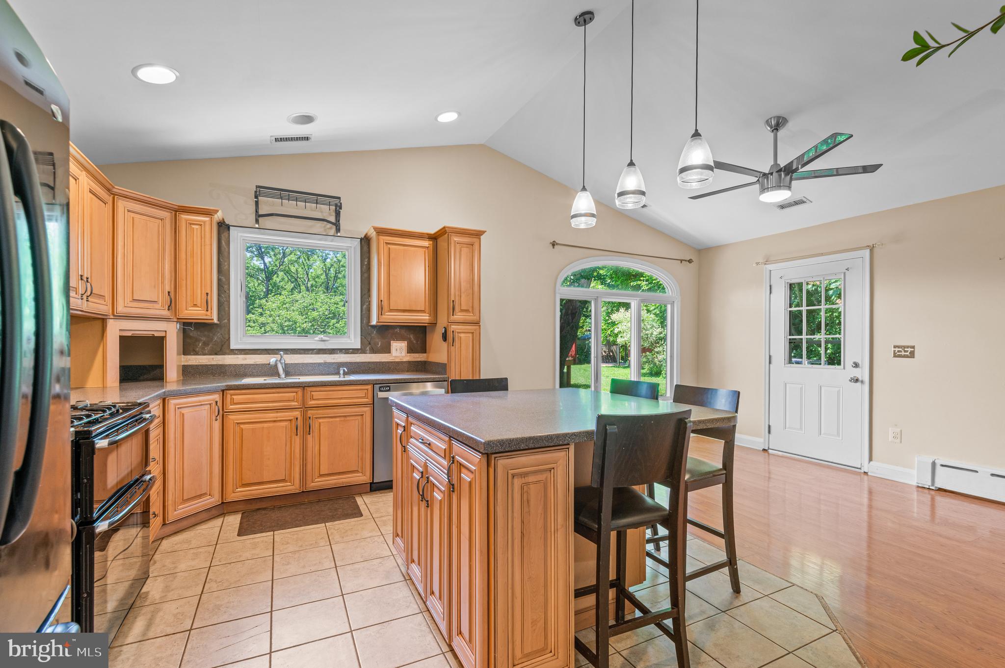 312 Whitaker Mill Road Fallston, MD 21047 - Photo 10 of 57 a open kitchen with stainless steel appliances granite countertop a stove a refrigerator a sink dishwasher a dining table and chairs with wooden floor