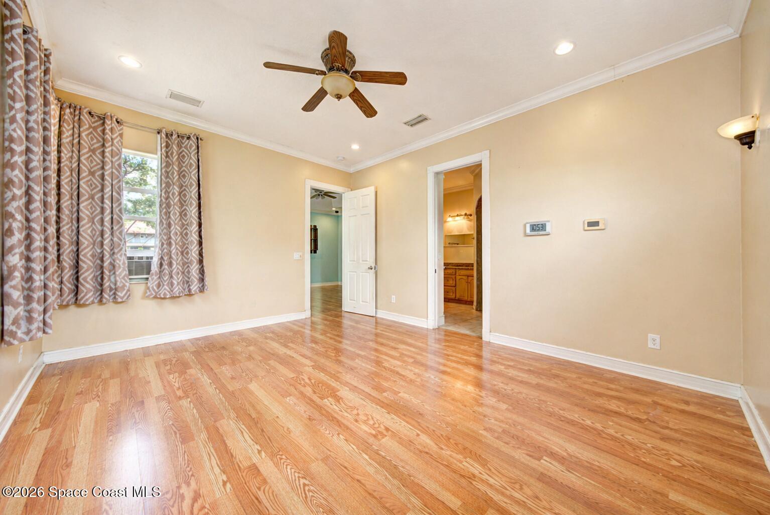 1090 Castile Road Southeast Palm Bay, FL 32909 - Photo 14 of 23 a view of empty room with wooden floor and fan