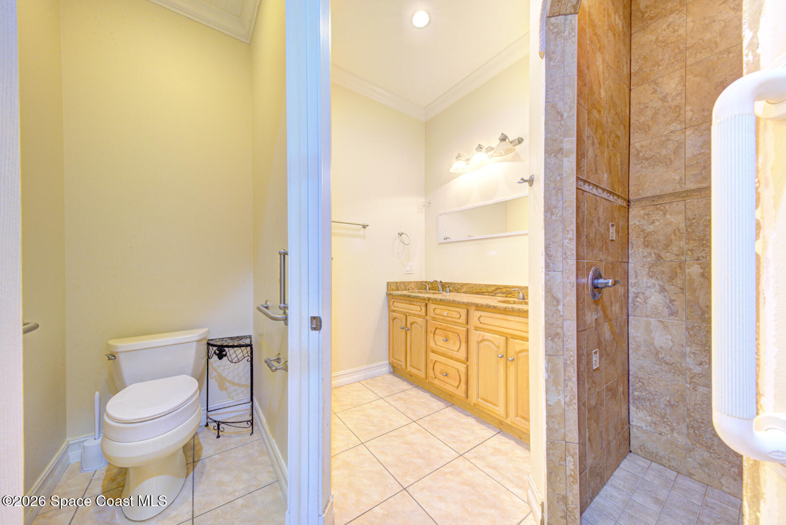 1090 Castile Road Southeast Palm Bay, FL 32909 - Photo 18 of 23 a bathroom with a granite countertop toilet and a shower