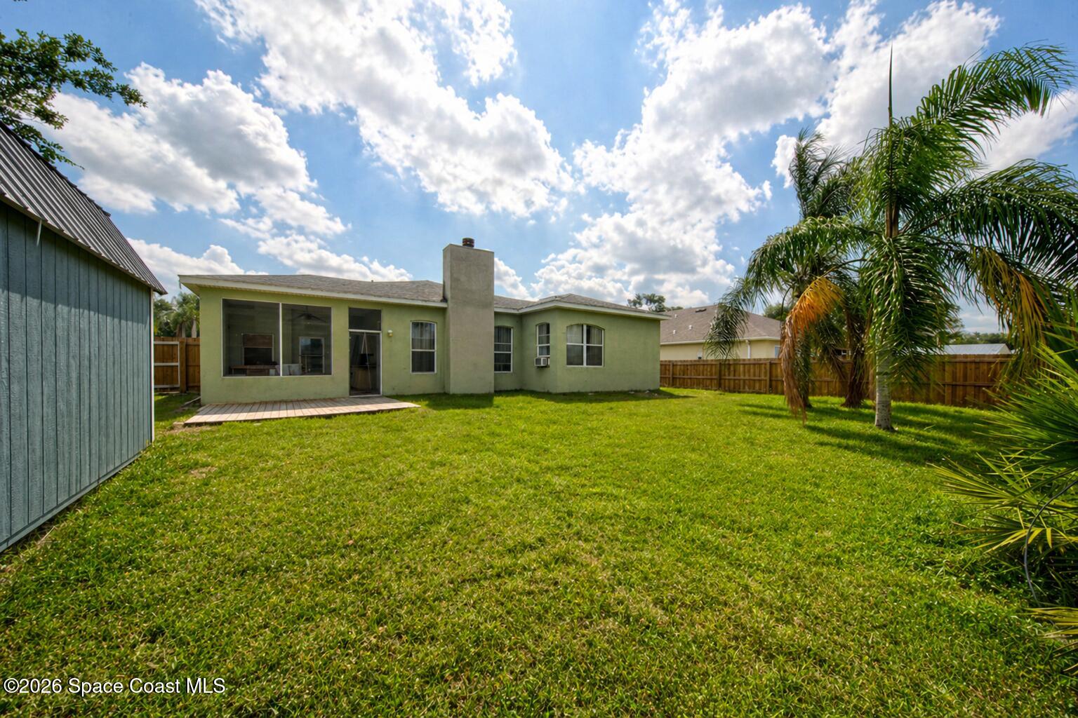 1090 Castile Road Southeast Palm Bay, FL 32909 - Photo 21 of 23 a view of a house with a backyard