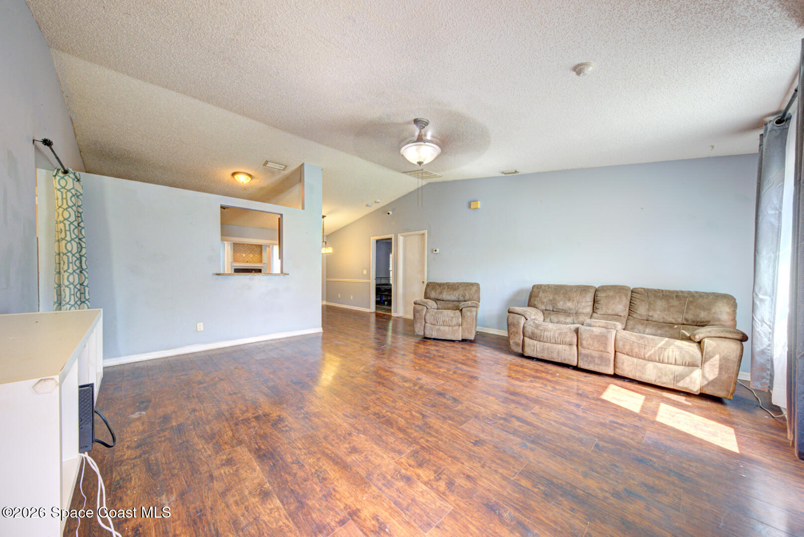 1090 Castile Road Southeast Palm Bay, FL 32909 - Photo 3 of 23 a living room with furniture and a wooden floor