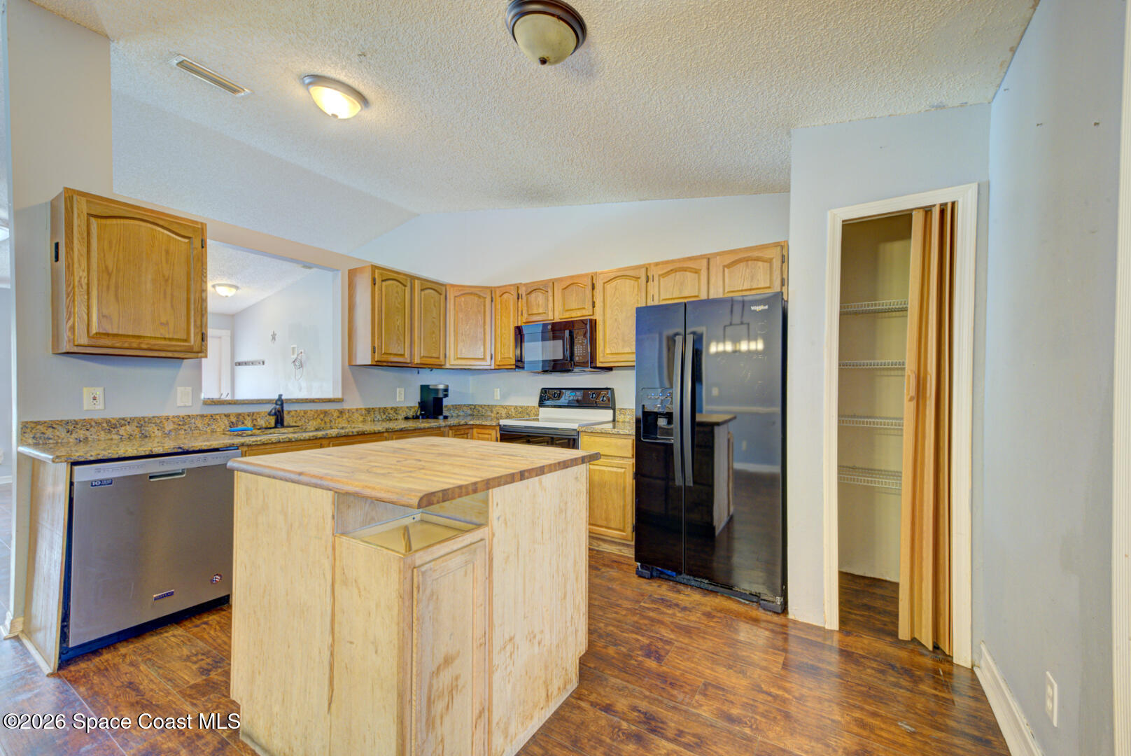 1090 Castile Road Southeast Palm Bay, FL 32909 - Photo 5 of 23 a kitchen with stainless steel appliances granite countertop a refrigerator and a stove top oven