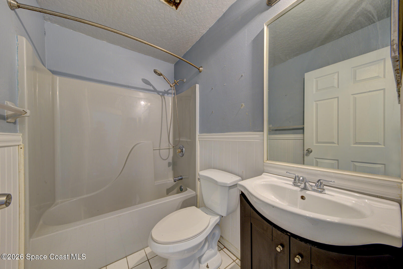 1090 Castile Road Southeast Palm Bay, FL 32909 - Photo 8 of 23 a bathroom with a sink toilet and shower