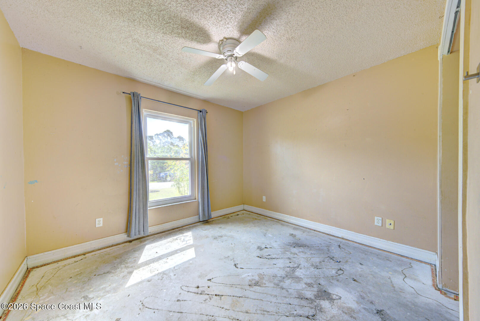 1090 Castile Road Southeast Palm Bay, FL 32909 - Photo 9 of 23 an empty room with fan and windows