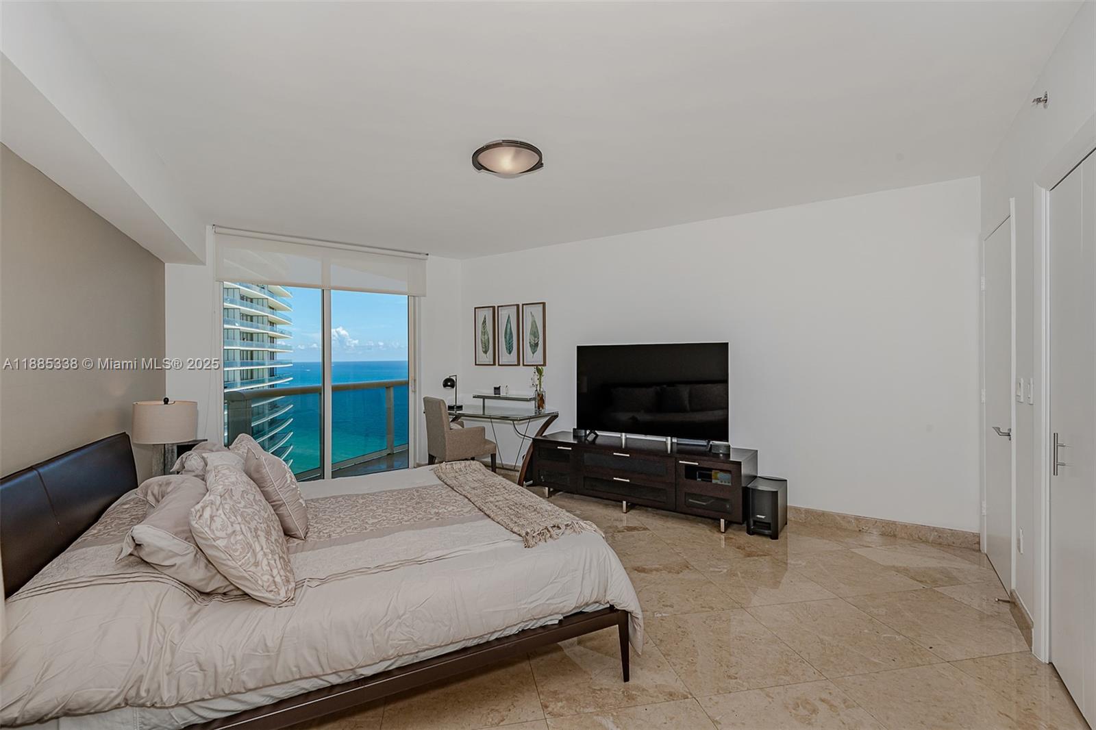 18911 Collins Avenue, Unit 3402 Sunny Isles Beach, FL 33160 - Photo 14 of 27 a bedroom with a bed and large window