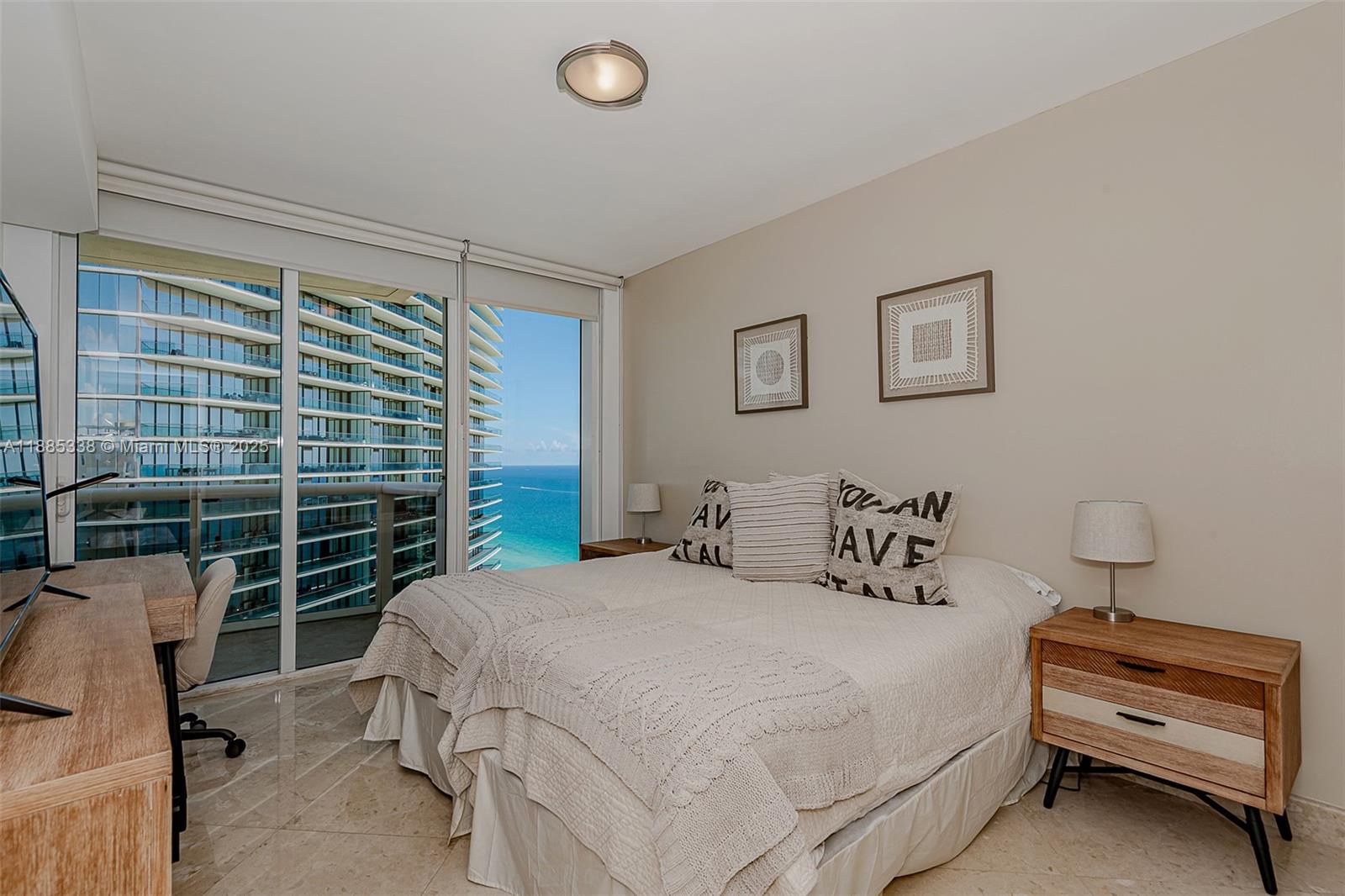18911 Collins Avenue, Unit 3402 Sunny Isles Beach, FL 33160 - Photo 20 of 27 a bedroom with a bed and a window
