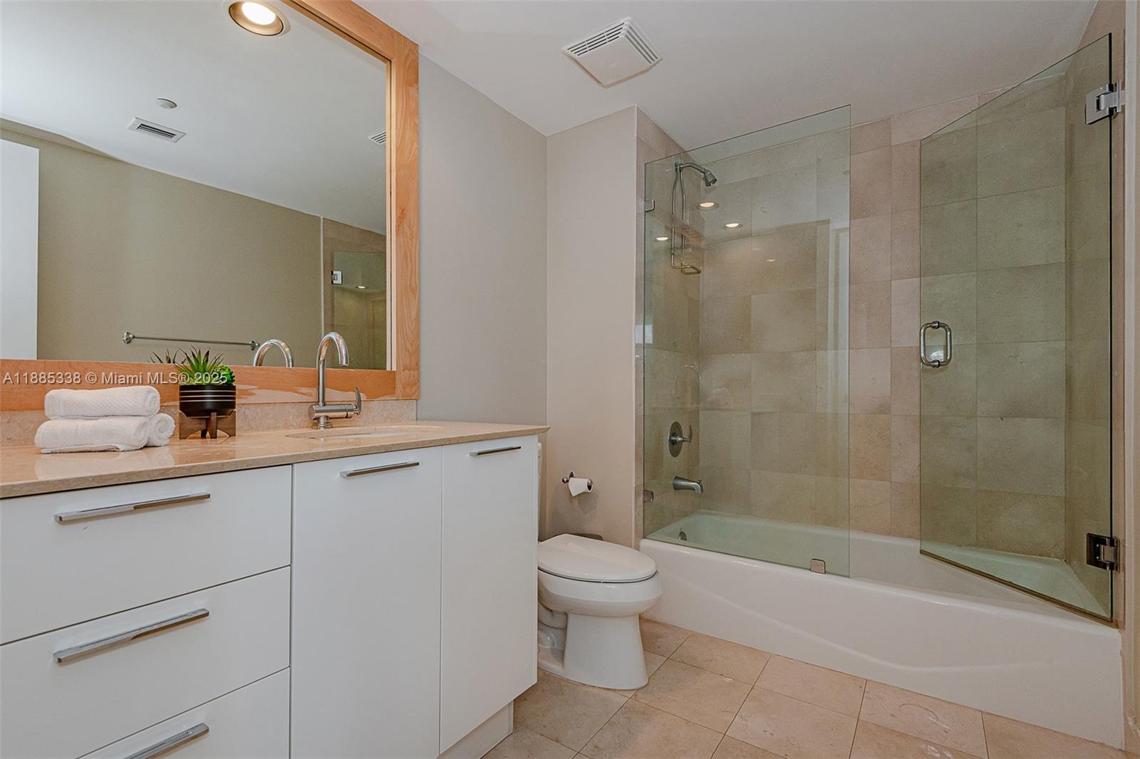18911 Collins Avenue, Unit 3402 Sunny Isles Beach, FL 33160 - Photo 23 of 27 a bathroom with a sink a toilet and shower