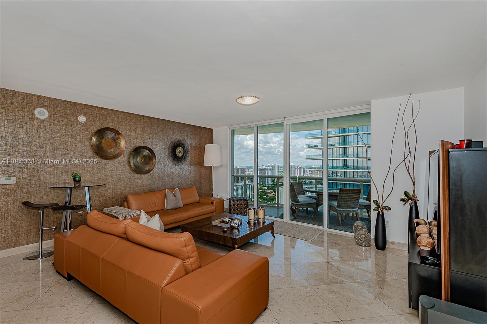 18911 Collins Avenue, Unit 3402 Sunny Isles Beach, FL 33160 - Photo 3 of 27 a living room with furniture and a large window