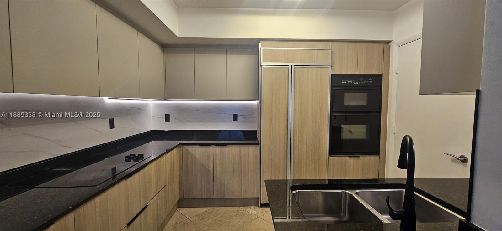 18911 Collins Avenue, Unit 3402 Sunny Isles Beach, FL 33160 - Photo 8 of 27 a kitchen with a refrigerator and a sink